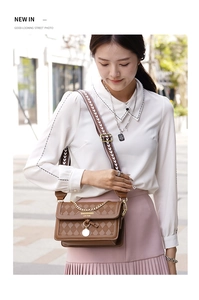 Detail of brown quilted crossbody bag featuring a golden chain and geometric woven strap