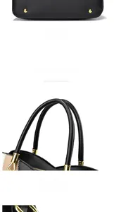 Detailed view of the pebbled leather handbag featuring gold studs and sturdy round handles