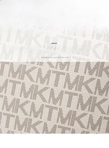 Close-up of white perforated PU leather texture with embossed monogram pattern