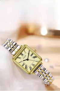 Detail of square quartz watch featuring Roman numerals and bicolor polished metal strap