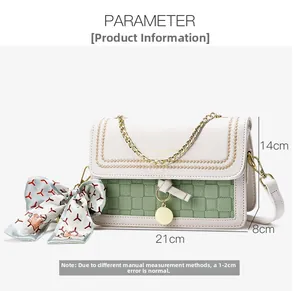 Detail of cream and green crossbody bag featuring woven texture and chain strap