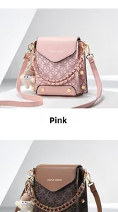 Detailed view of pink and dark brown crossbody phone bags with unique monster charms