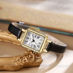 Vintage women's square gold watch with black leather strap and Roman numerals dial