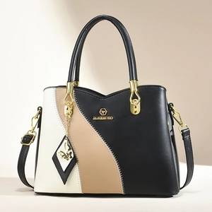 Elegant tri-color patchwork leather tote bag with gold butterfly charm and shoulder strap