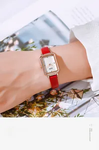 Close-up of elegant GEDI women's quartz watch with rose gold case and red leather strap