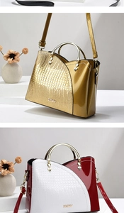 Détail du sac à main avec motif crocodile, poignées métalliques et design bicolore