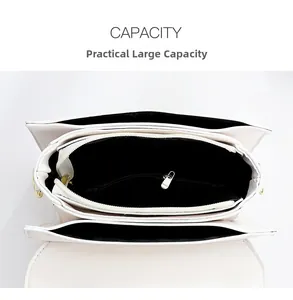 Top view of white leather crossbody bag interior showing large capacity and compartments