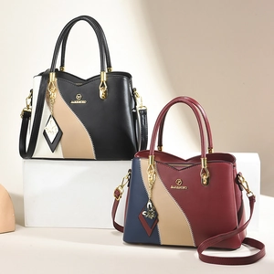 Minimalist color-block PU leather tote bag with top handle and butterfly charm pendant