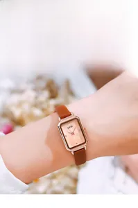 Detail of GEDI rectangular quartz watch featuring rose gold case and brown leather strap