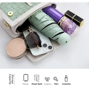 Interior view of small crossbody bag showing large capacity for umbrella and phone