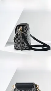 Detail view of jacquard patterned crossbody phone bag with gold hardware and strap