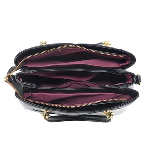Women's black leather tote bag with gold hardware and spacious multi-compartment interior