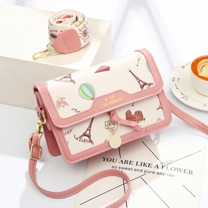 Pink and beige crossbody bag with world landmark prints and two detachable shoulder straps