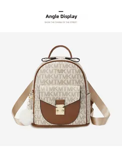Detail view of stylish monogram backpack with leather trim and decorative fur ball charm