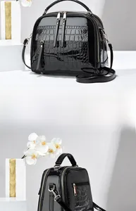 Détails du sac à main en cuir verni noir avec motif crocodile et finitions dorées