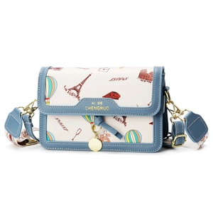 Travel-themed crossbody bag with Eiffel Tower illustration and blue leather trim