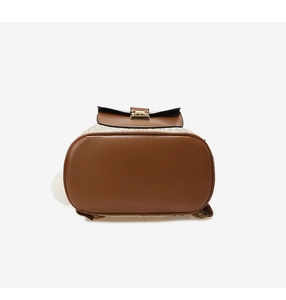 Detail of monogrammed backpack base with premium brown leather and gold hardware
