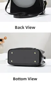 Vue détaillée du sac noir à motif crocodile montrant les clous dorés de protection