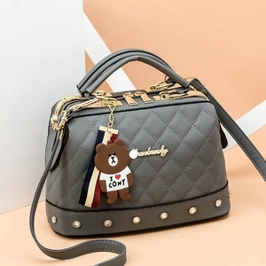 Chic grey quilted Boston handbag with gold studs and adjustable shoulder strap