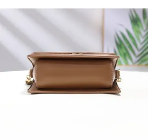 Detail showing high-quality brown leather bag bottom with white precision stitching