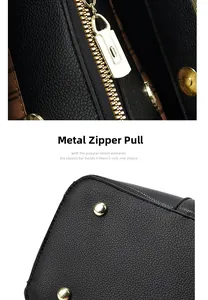 Detail of black litchi texture leather handbag with golden zipper and metal studs