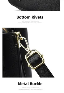 Detail of black pebbled leather handbag with gold metal feet and sturdy hardware clasps