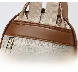 Close-up of reinforced shoulder strap stitching on monogram print fashion backpack