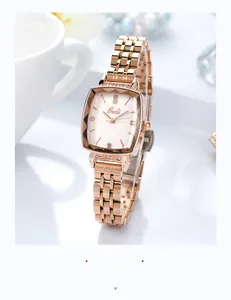 Close-up of rose gold tonneau quartz watch with diamond accents on a white porcelain cup
