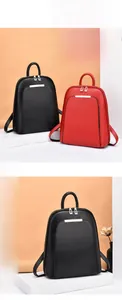 Detail view of stylish women's backpacks in black and red with gold zippers and metal trim