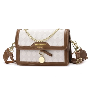 Women's retro quilted crossbody bag in beige with brown trim and dual chain straps