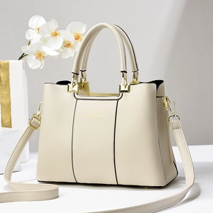 Elegant off-white lychee pattern leather handbag with gold hardware and top handle