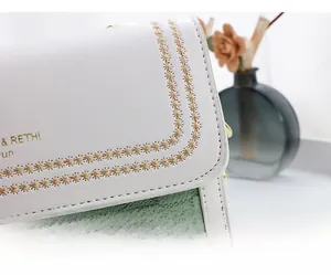 Close-up of contrast leather bag featuring star embroidery and precision stitching details