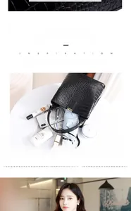 Detail showing high capacity of black faux crocodile skin bucket bag for daily essentials