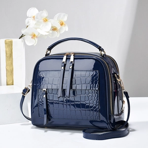 Glossy dark blue faux leather handbag with crocodile pattern detail and gold hardware