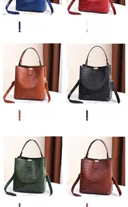 Detail showing six colors of faux crocodile pattern bucket bags with detachable straps