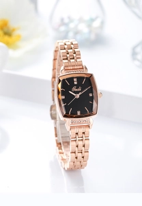 Detailed side view of rose gold square watch featuring geometric cut glass and crystal markers