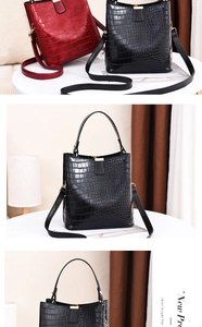 Detail of glossy stone pattern bucket bag with metal buckle and detachable strap