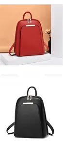 Detail view of stylish red and black minimalist backpacks with dual zipper and top handle
