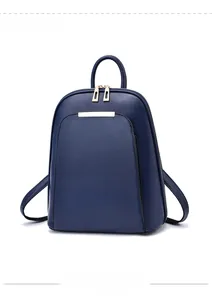 Detail view of navy blue structured backpack with golden zippers and metal bar accent