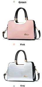 Detailed macro view of glossy patent leather texture and gold hardware on pink handbag