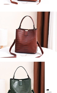 Detail of vintage crocodile pattern bucket bags in brown and green with gold magnetic buckle
