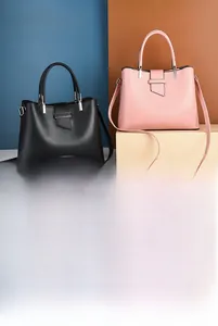 Detailed view of structured matte leather handbags with metal buckles and detachable straps