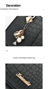 Close-up of golden metal flower charm and brand logo on black crocodile pattern leather bag