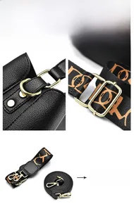 Detail showing high-quality gold hardware and two detachable shoulder straps on black bag