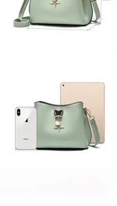 Detailed view of mint green bucket bag dimensions 23x11x16cm with gold star pendant
