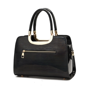 Elegant black patent leather tote bag with gold hardware and stylish horizontal texture