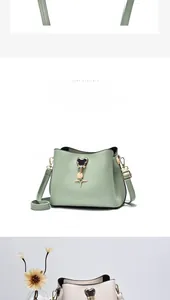 Detail of mint green and beige bucket bags with Mickey outline charms and gold hardware