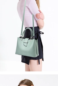 Detail of light green leather shoulder bag with NICKY MARLOWE logo and silver hardware