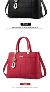 Close-up of black and burgundy quilted leather handbags with gold metal hardware
