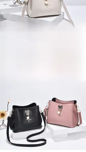 Detail of elegant bucket bags in cream, black, and pink with glitter mouse charms